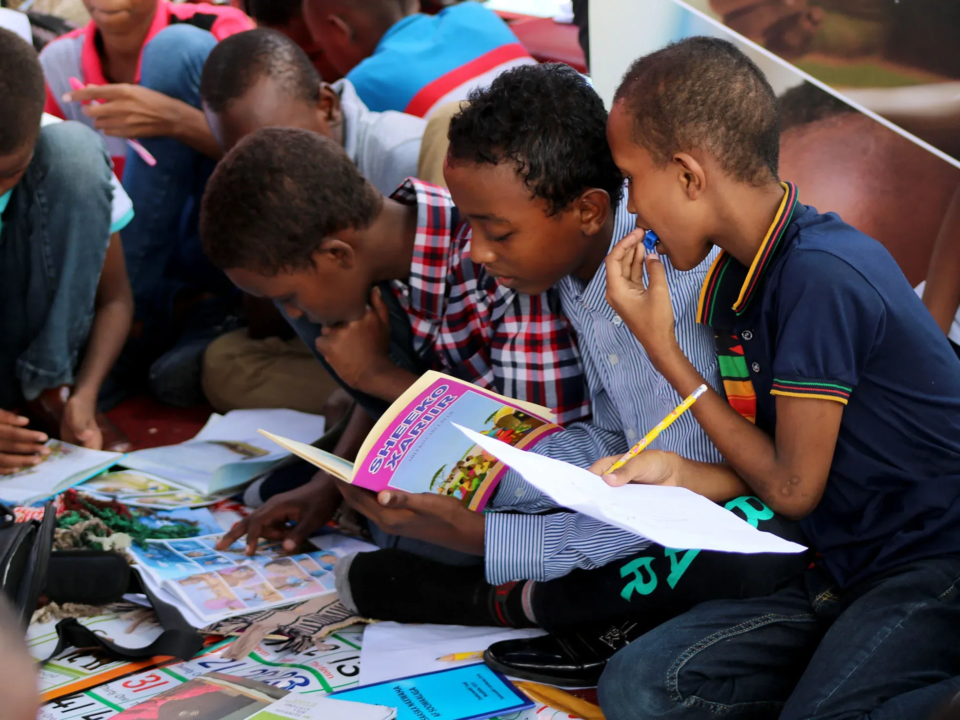 Refugee children studying books